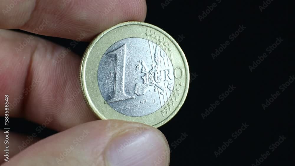 One euro cent shining in man hand, close up footage. Macro coins. One euro cent shining in man hand, close up footage. Macro coins.