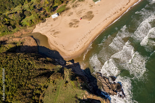 Golden sands beach, waves. Tandem motor paragliding over Black Sea shores near town of Ahtopol. Sunny autumn day, scenery colors and amazing landscapes and seascapes, Bulgaria photo