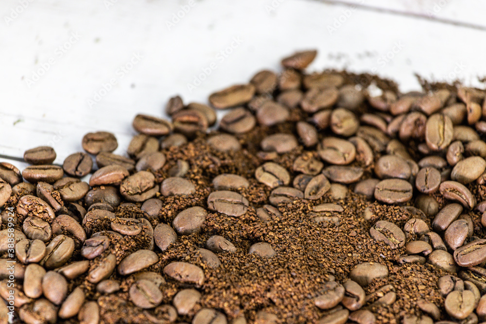 roasted coffee beans on white wood background roasted coffee beans on white wood background