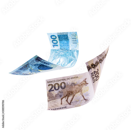 200 and 100 reais bills falling, isolated white background, brazilian money, brazilian economy photo