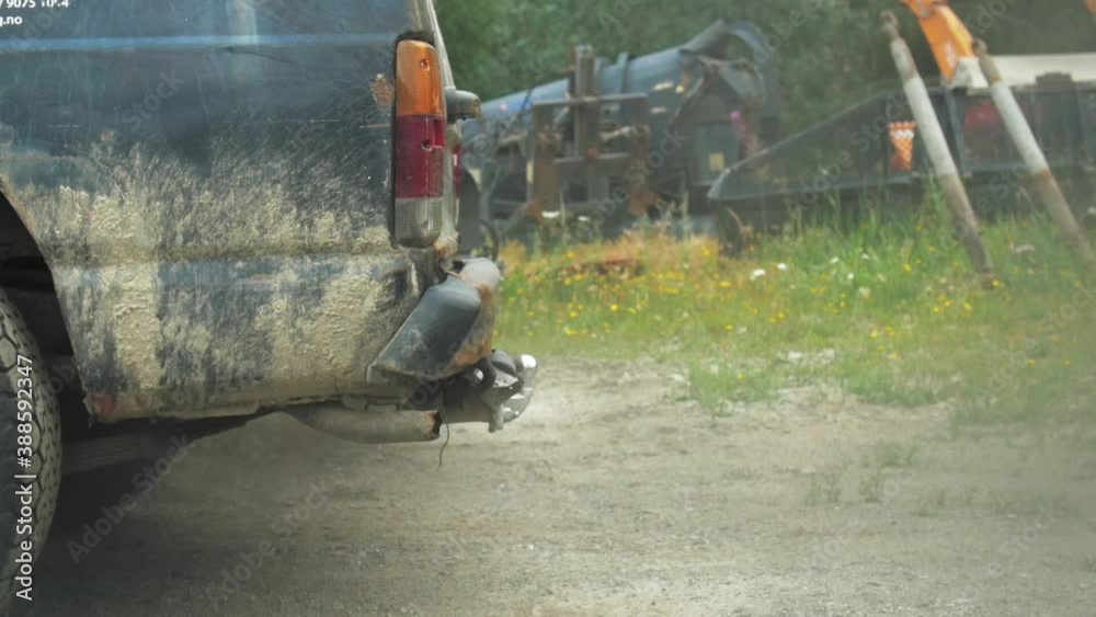 Dark smoke pollution coming out of exhaust of dirty old black truck on