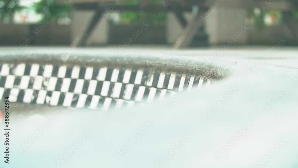 Close up of a skateboarder dropping in concrete bowl at skatepark, low angle