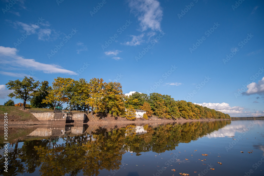 Lake level on an autumn afternoon. Reflecting cloudy sky. Lake level on an autumn afternoon. Reflecting cloudy sky.
