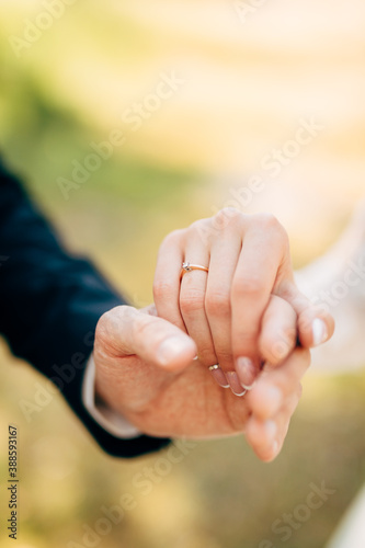 hands of groom and bride hold together