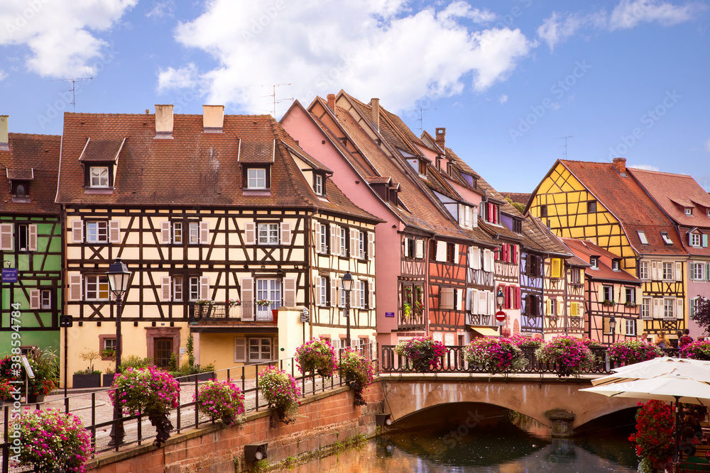 Picturesque view on Colmar street. Half-timbered houses, Colourful architecture, canal and blue sky. Travel destination. Alsace, France
