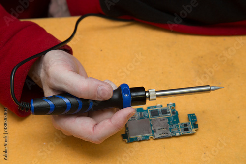 Soldering iron for electronic boards. A tool for repairing electronic components.