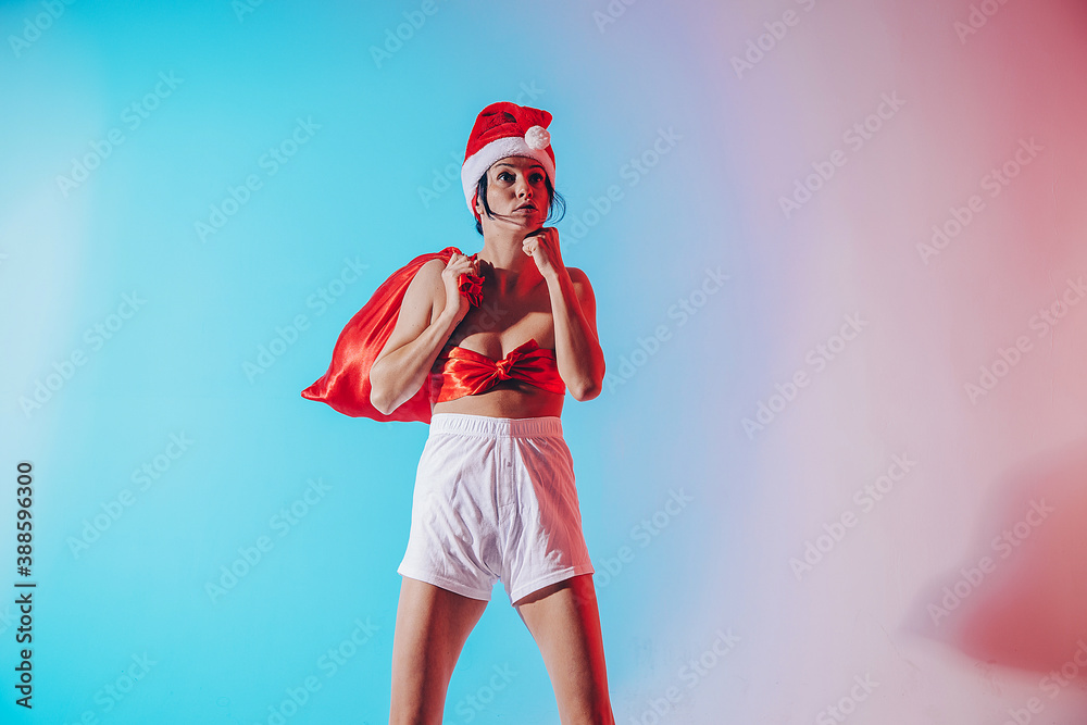 Obraz premium Beautiful female model wear santa hat. Santa hat. Christmas woman. Life. Funny photo. Christmas time. 
