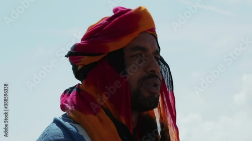 Man in traditional blue Tuareg dresses, in the Sahara desert in Morocco.