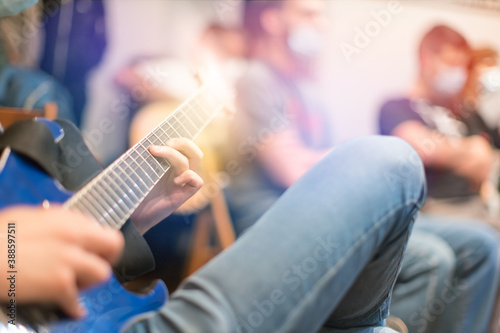 man playing guitar at guitar lesson