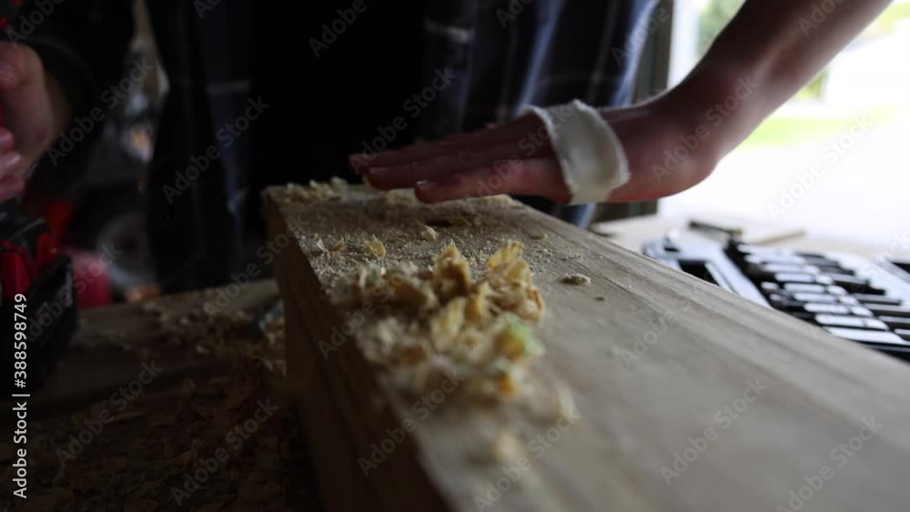 An individual works on a woodworking project from the perspective of his hands. An individual works on a woodworking project from the perspective of his hands.