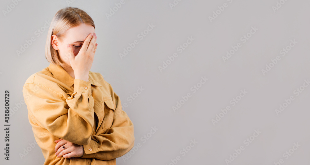 Embarrassed annoyed adult woman hiding face bend head down, facepalm, smirk irritated, not looking friend acting weird, feel humiliated uncomfortable, standing gray background Embarrassed annoyed adult woman hiding face bend head down, facepalm, smirk irritated, not looking friend acting weird, feel humiliated uncomfortable, standing gray background