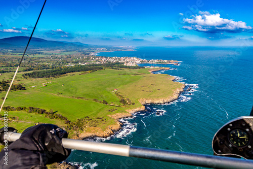 Town of Ahtopol in background. Tandem motor paragliding over Black Sea shores near town of Ahtopol. Sunny autumn day, scenery colors and amazing landscapes and seascapes, Bulgaria photo