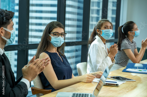 Group of business people wear mask for protect prevent infection by corona virus are meeting in modern bright office.