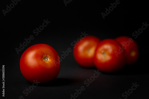 red tomatoes on black background