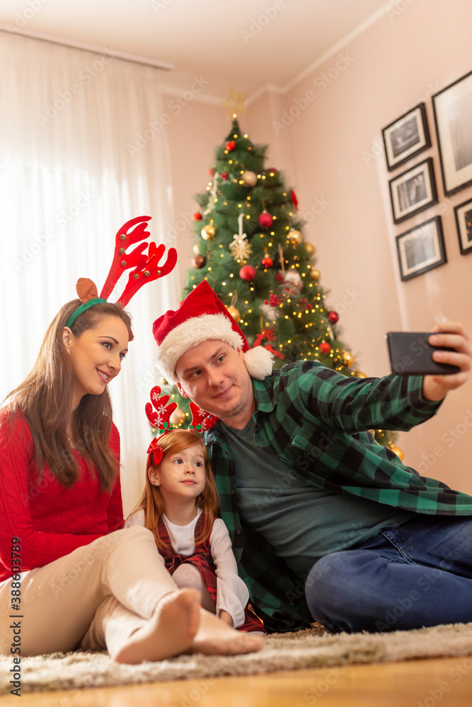 Family taking selfie while celebrating Christmas Family taking selfie while celebrating Christmas