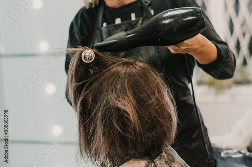 Hairdresser Using Dryer on Woman Wet Hair in Salon. Short Hair. Hairstyle