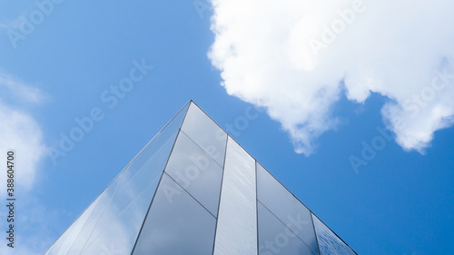 glass structure with blue sky and clouds on the background