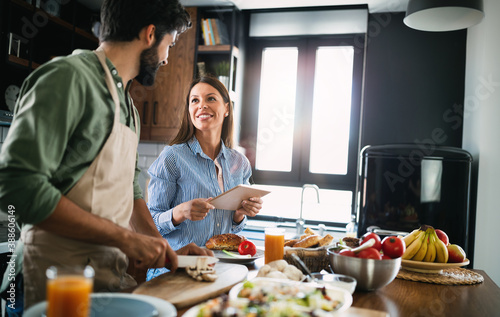 Happy couple cooking together in their kitchen