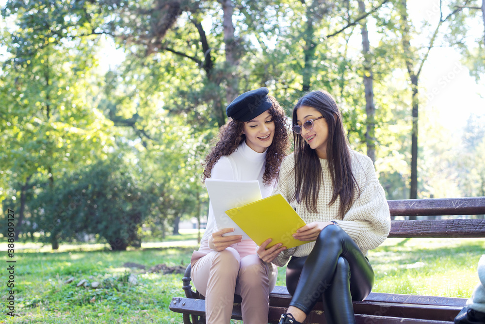 Two happy Students outdoor with books Two happy Students outdoor with books