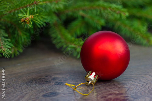 a Christmas tree toy in the form of a red ball hangs on the floor waiting for the Christmas tree to be decorated