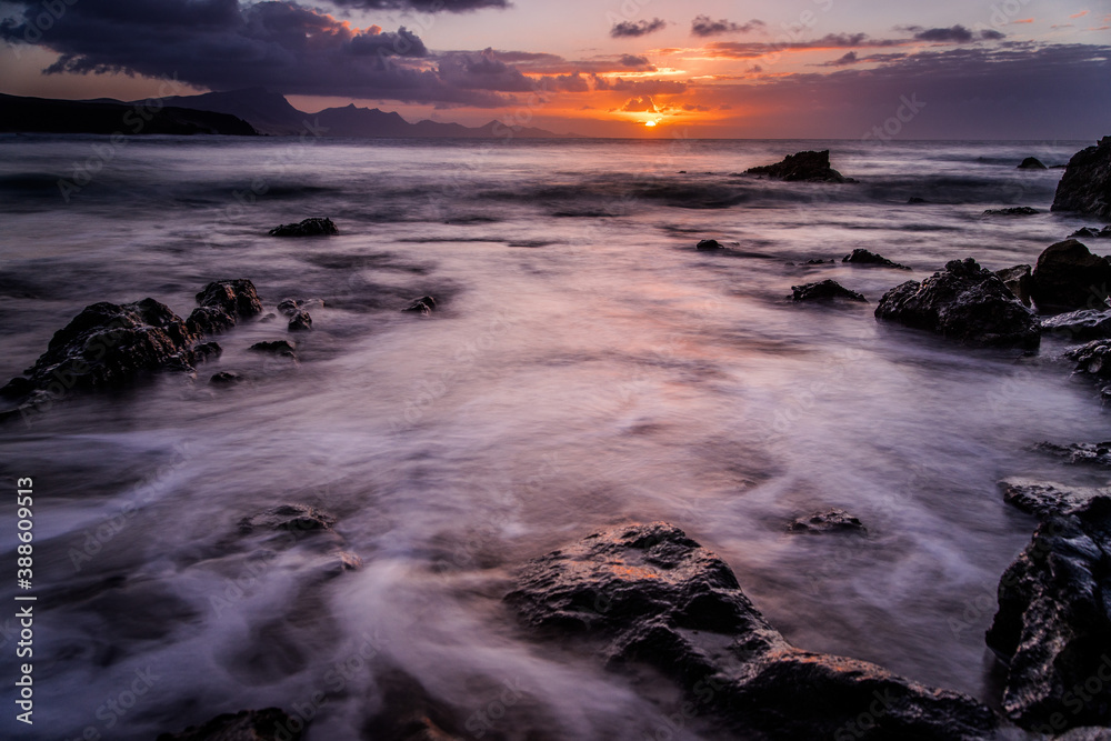 Waves and sunset at the coastline of Fuerteventura