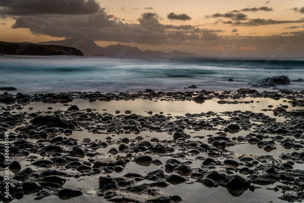 Waves and sunset at the coastline of Fuerteventura