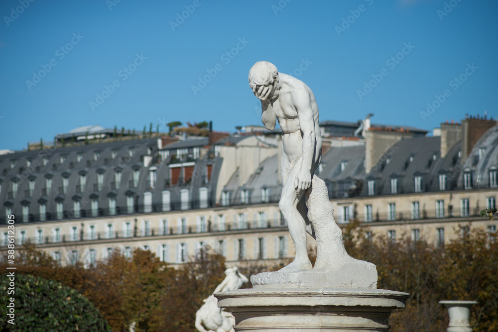 Statue of cain in tuileries garden in Paris on Rivoli street background