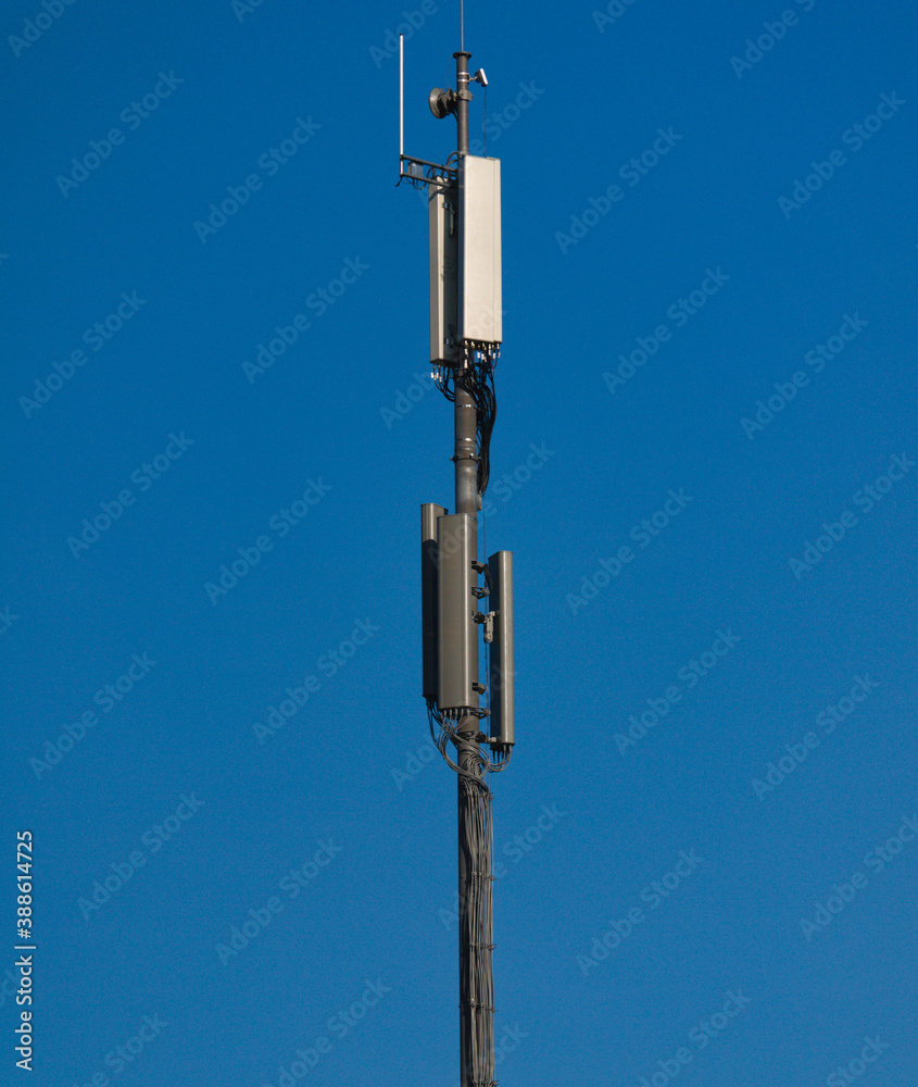 A GSM antenna on a sky blue background A GSM antenna on a sky blue background