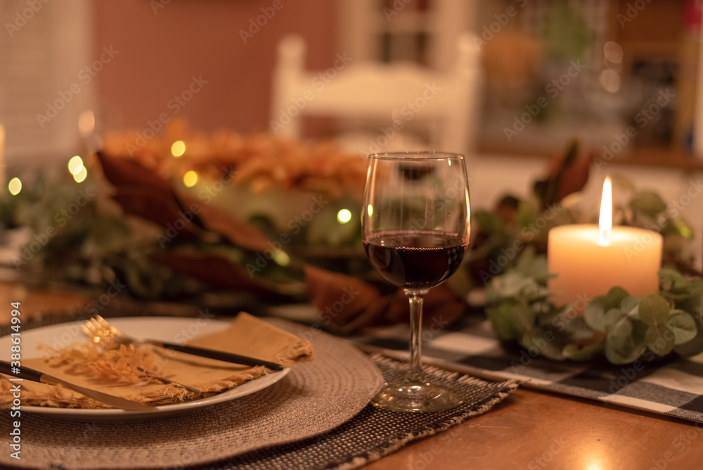 Holiday table setting by candlelight - celebrating at home Holiday table setting by candlelight - celebrating at home