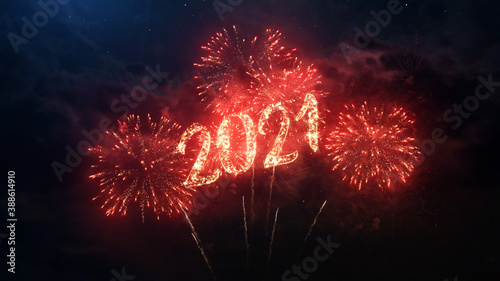 2021 Happy New Year greeting text with particles and sparks on black night sky with colored fireworks on background, beautiful typography magic design.