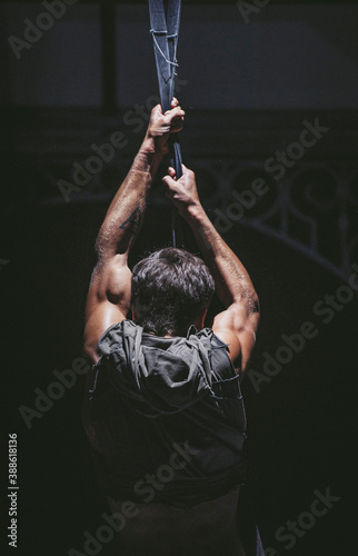 View on strong hands of young bodybuilder in time of training