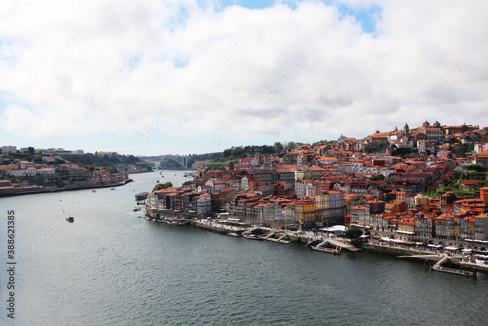 Portuguese city of Porto, view from the waterfront. Houses and a river with ships and boats