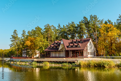 A small complex hotel in the forest consisting of several houses in pines on the banks of the river.