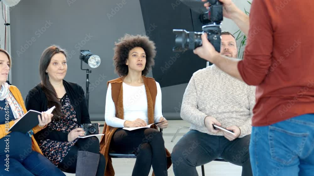 Attendees taking photography lessons from an experienced photographer in the studio. Attendees taking photography lessons from an experienced photographer in the studio.
