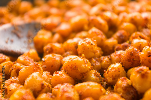 Cooking chickpeas with spices in a pan  close-up