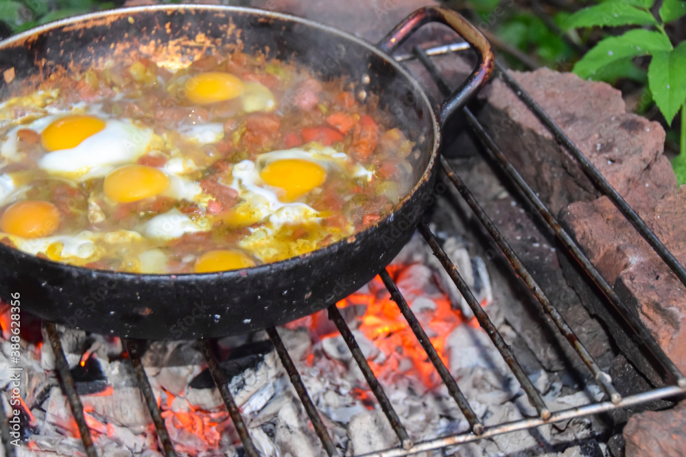 scrambled eggs on a campfire camping in the nature Shakshouka national cuisine scrambled eggs on a campfire camping in the nature Shakshouka national cuisine