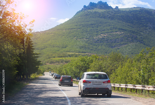 Cars move along a winding mountain road