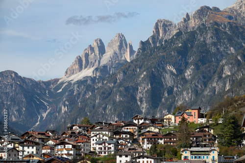 CLOSE UP: Picturesque view of rustic buildings under a ridge in the Dolomites.