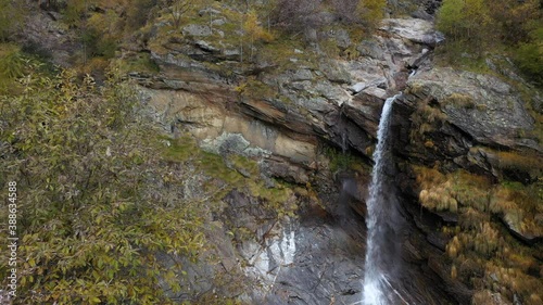 Waterfall and river in the mountains during autumn - aerial shot photo