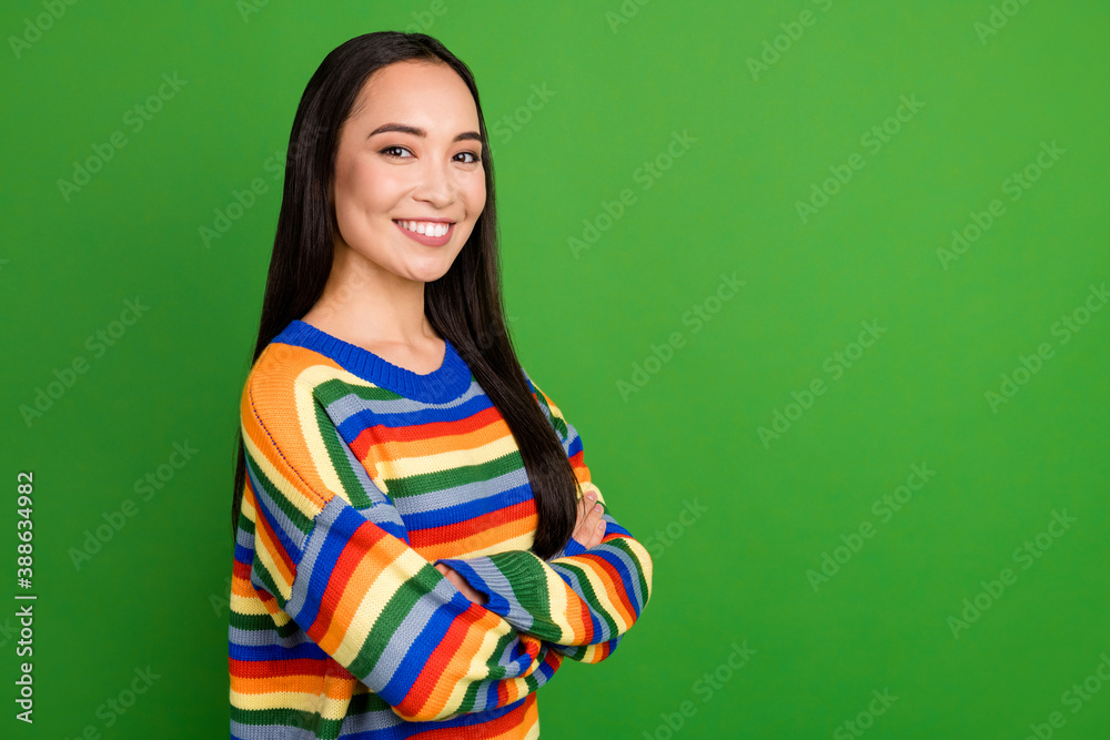 Profile side view portrait of pretty content cheerful girl folded arms copy space isolated over vibrant green color background Profile side view portrait of pretty content cheerful girl folded arms copy space isolated over vibrant green color background