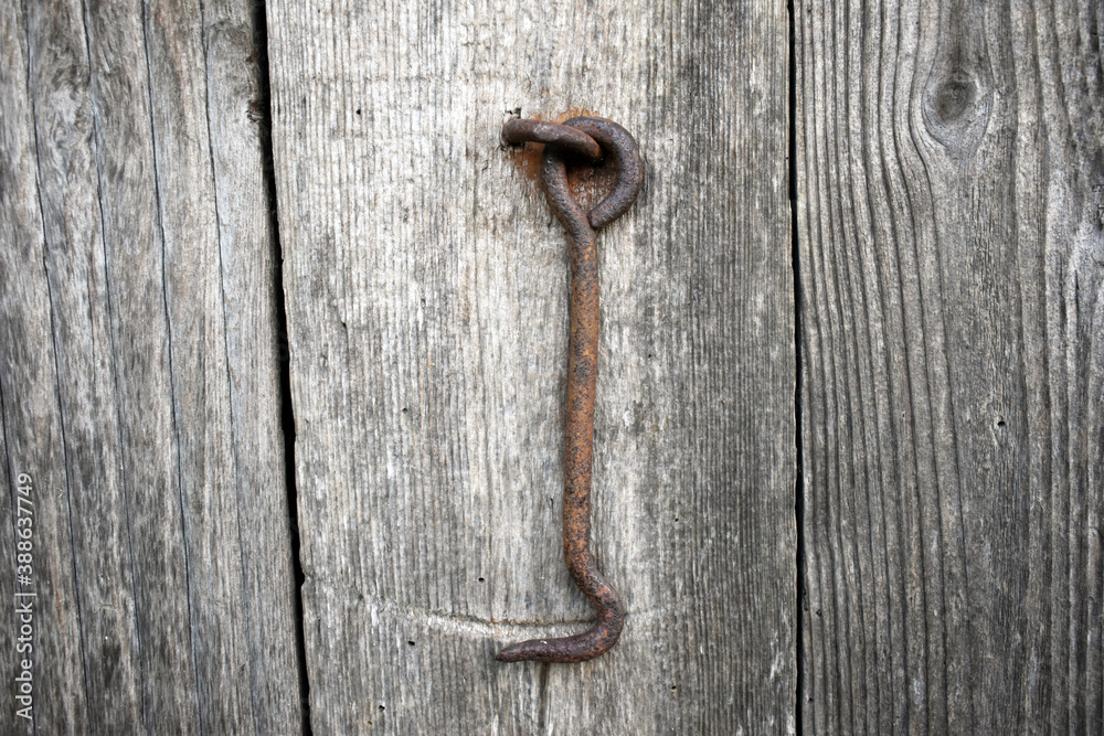 Village theme. Close-up photo of the hook for closing the barn door Village theme. Close-up photo of the hook for closing the barn door