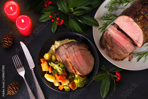 Roasted beef. Christmas decorations. New Year dinner table. View from above, top studio shot