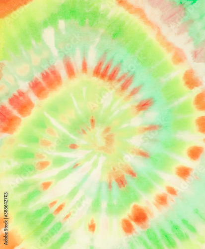 Spiral tie dye background. Tie dye wallpaper. Tie-dye pattern. Tiedye backdrop. Green orange lemon lime tiedye texture. 