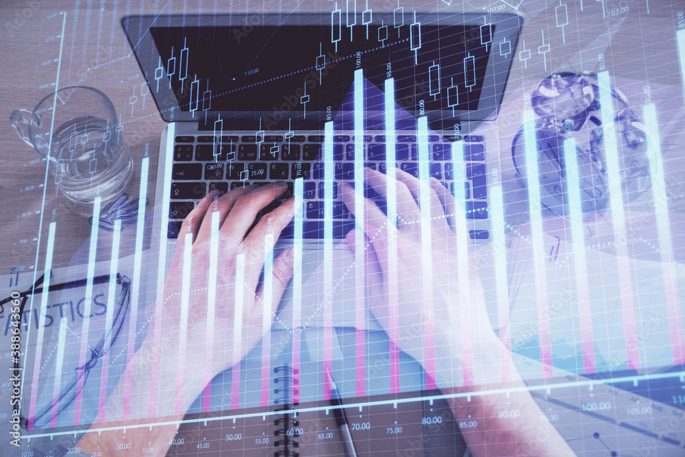 Naklejka premium Multi exposure of man's hands typing over computer keyboard and forex graph hologram drawing. Top view. Financial markets concept.