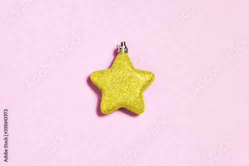 Christmas star decoration on pink paper background. Christmas minimal concept