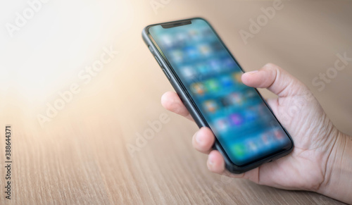 Wallpaper Mural Female hand holding smartphone for find something on internet or shopping online while sitting one person for one table in the Co-working space Torontodigital.ca