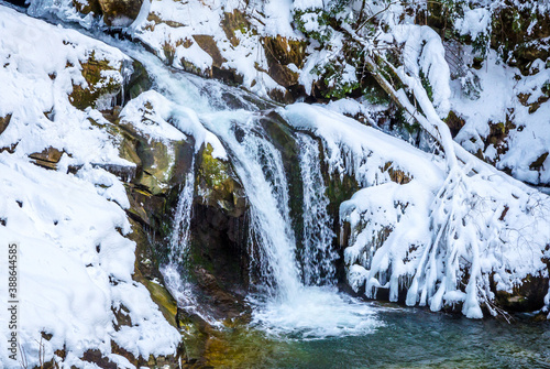 Beautiful mountain river waterfall in winter