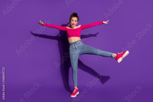 Full length body size view of attractive childish cheerful cheery girl having fun jumping isolated over bright violet color background