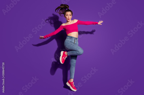 Full length body size view of lovely funky cheery girl having fun jumping pout lips having fun isolated bright violet color background