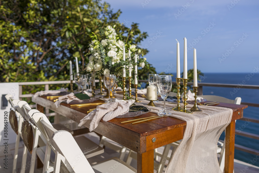 White and Gold Romantic Wedding Table Top Layout Table Spread no people no human tropical location with gold cutlery and scenic view tablescape